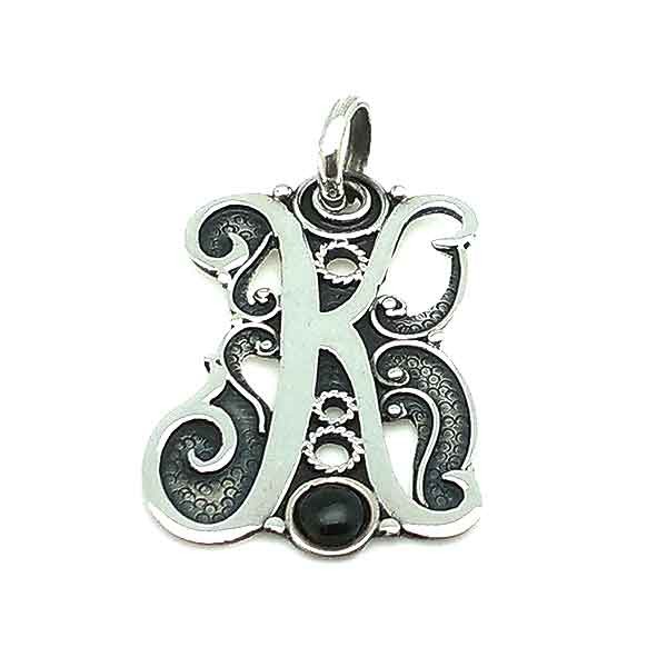 Initial in silver and jet, letter K.