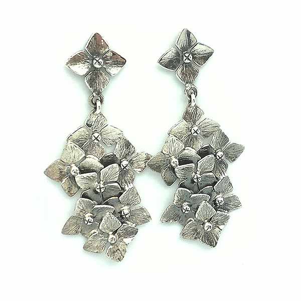 Long sterling silver designer earrings with many flowers.