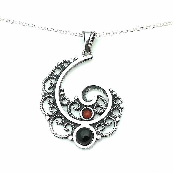 Pendant, made in the shape of a spiral, in sterling silver, jet and coral.