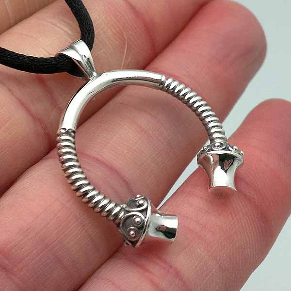 Men's pendant, shaped like a torque, in silver.