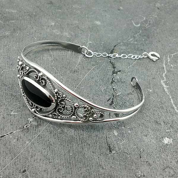 Bangle type bracelet, in silver and jet.