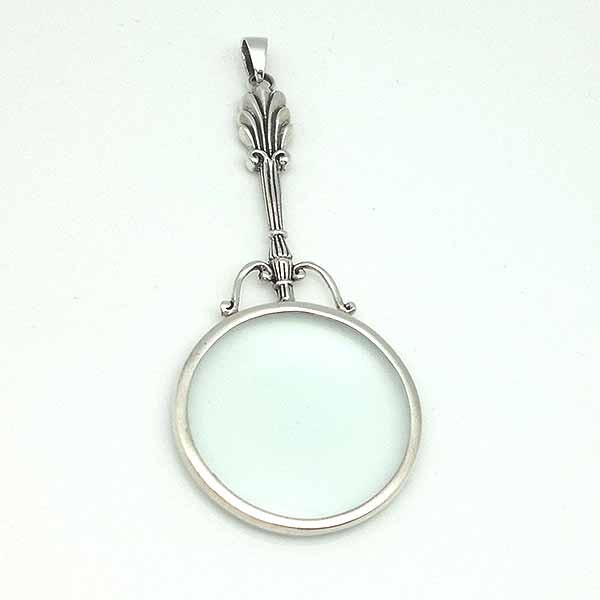 Pendant in sterling silver, shaped like a magnifying glass.