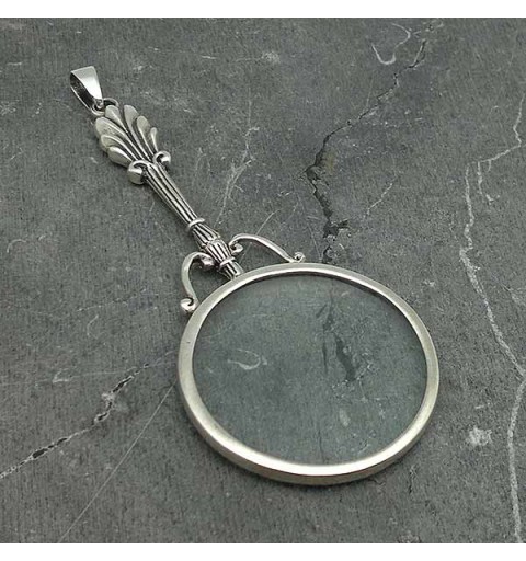 Pendant in sterling silver, shaped like a magnifying glass.