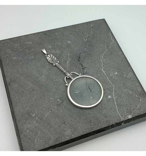 Pendant in sterling silver, shaped like a magnifying glass.