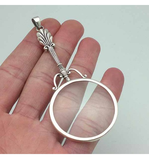 Pendant in sterling silver, shaped like a magnifying glass.