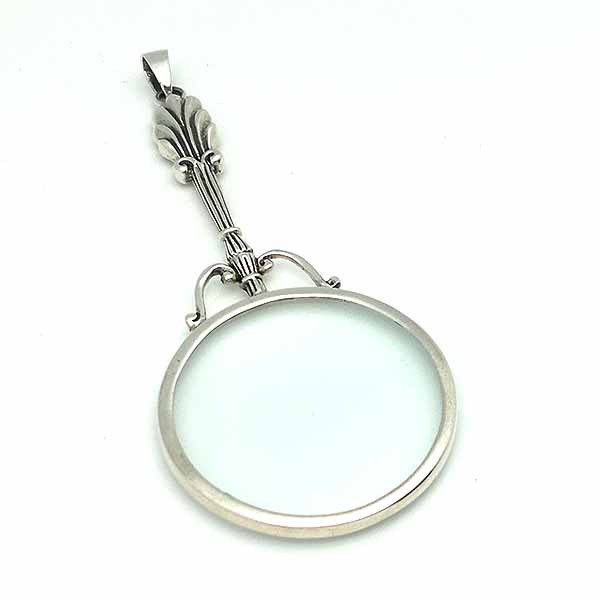 Pendant in sterling silver, shaped like a magnifying glass.