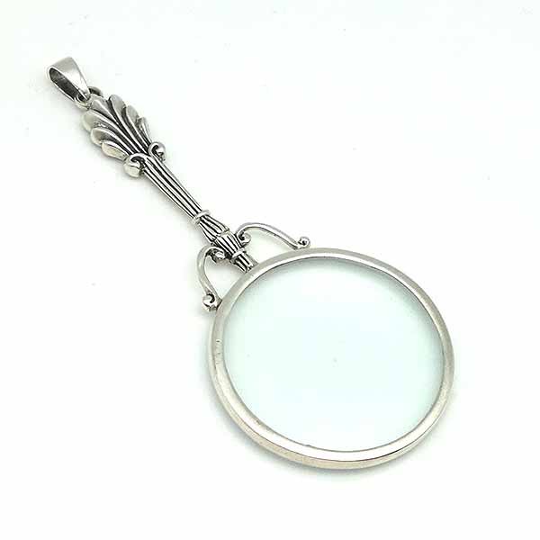 Pendant in sterling silver, shaped like a magnifying glass.