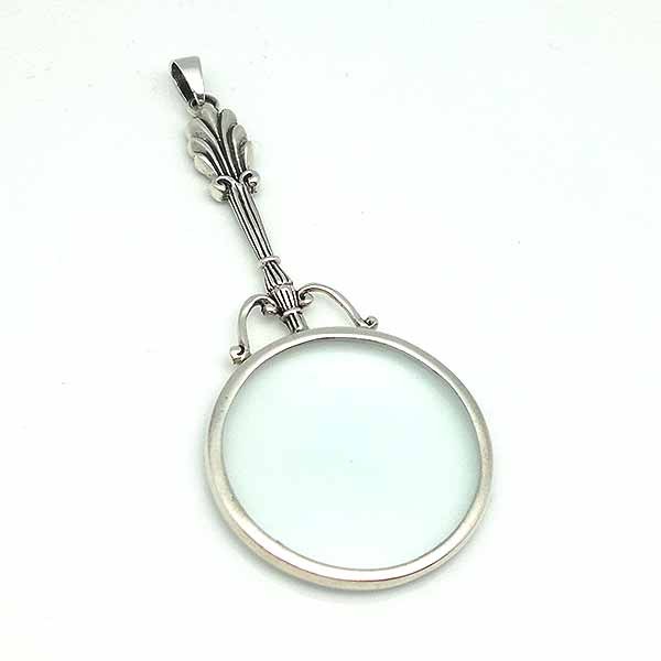 Pendant in sterling silver, shaped like a magnifying glass.