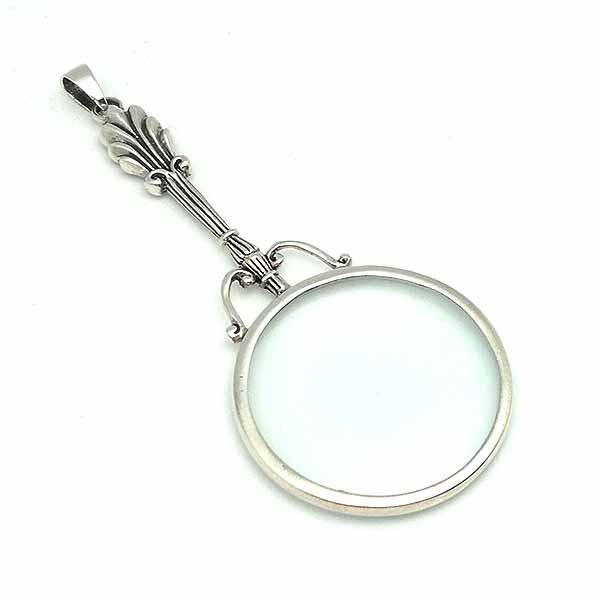 Pendant in sterling silver, shaped like a magnifying glass.