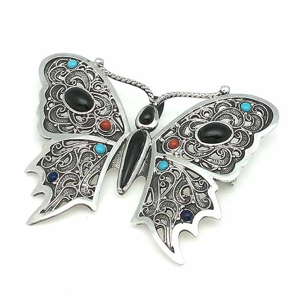 Brooch and pendant, in the shape of a butterfly, made by hand, in sterling silver and natural pieces.