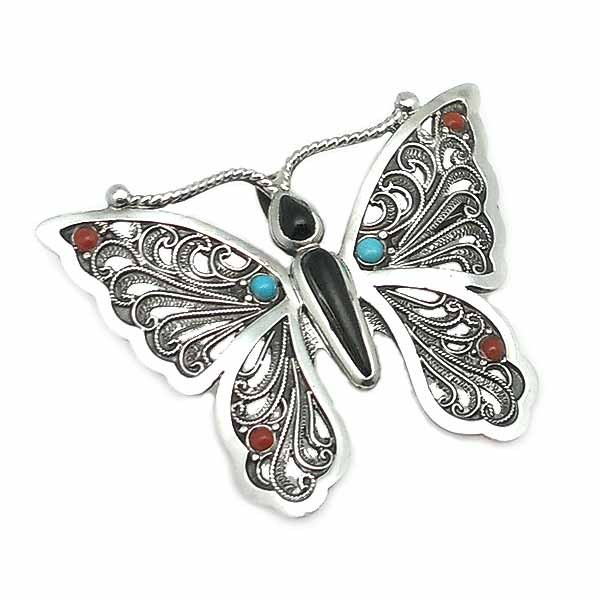 Broche con la forma de una mariposa, elaborado a mano en plata de ley y piedras naturales.