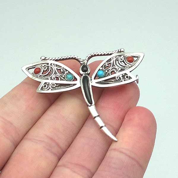 Dragonfly brooch, in sterling silver, jet, coral and turquoise.
