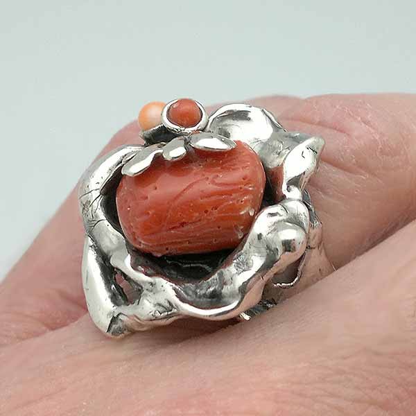Baroque style ring, made of sterling silver and natural coral.
