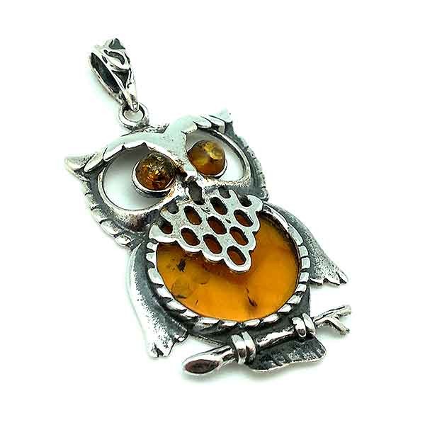 Pendant, shaped like an owl, made of silver and amber.