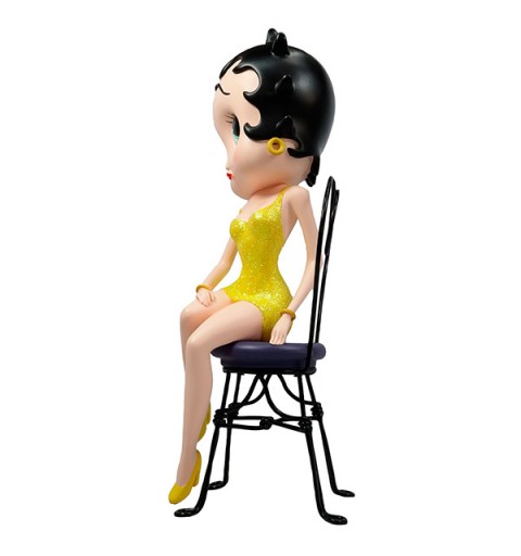 Betty boop, sitting on a chair in a yellow dress