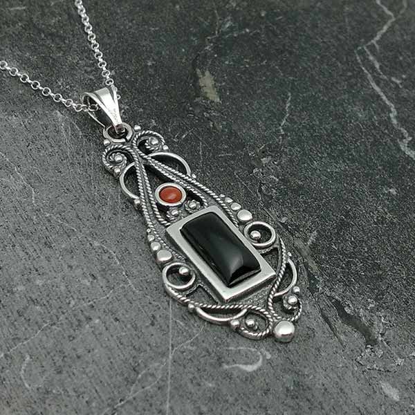 Jet pendant, sterling silver and coral.