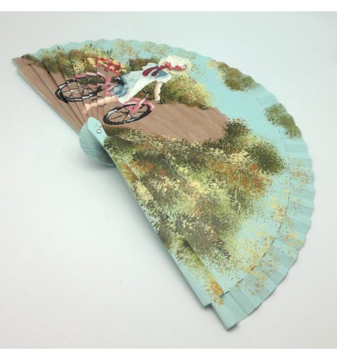 Hand-painted fan, in which we can see a girl taking a ride on a pink bicycle.