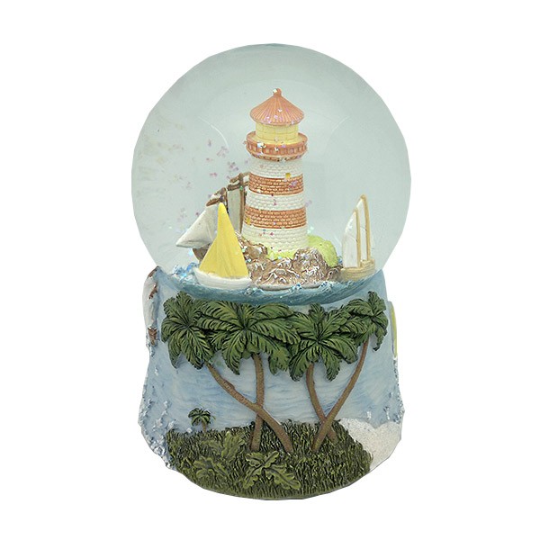 Snow globe with lighthouse and boats