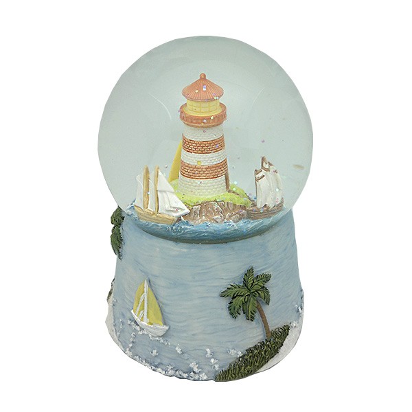 Snow globe with lighthouse and boats