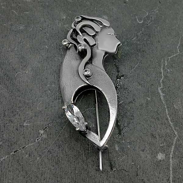 Brooch with the silhouette of a woman made of sterling silver.