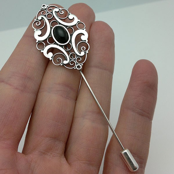 Pin-type brooch, in sterling silver and jet.