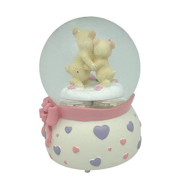 Snow globe with teddy bears, features music and movement