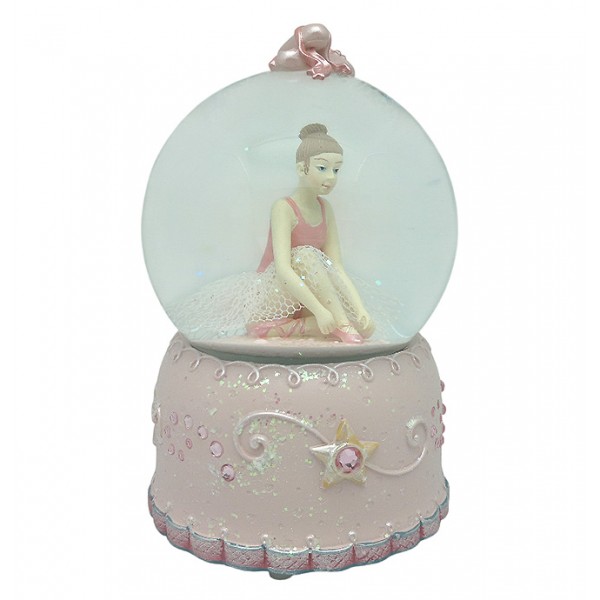Snow globe, in which we can see a ballerina adjusting her pointe shoes.